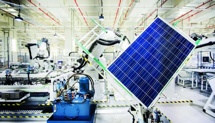 A robot handles a solar panel on the module production line at the REC Solar ASA manufacturing facility in Singapore